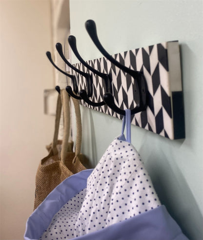 Black Coat Hooks On Black And White Plaque